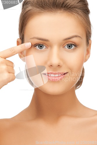 Image of woman touching her face skin