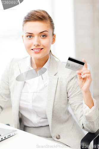 Image of businesswoman with laptop showing credit card