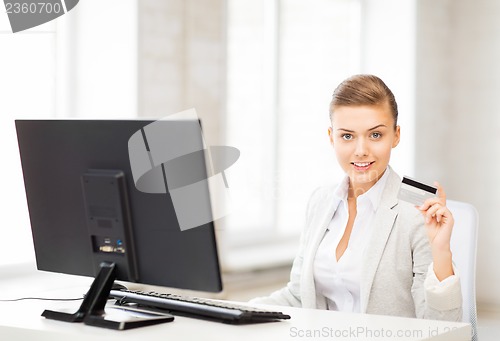 Image of businesswoman with computer using credit card
