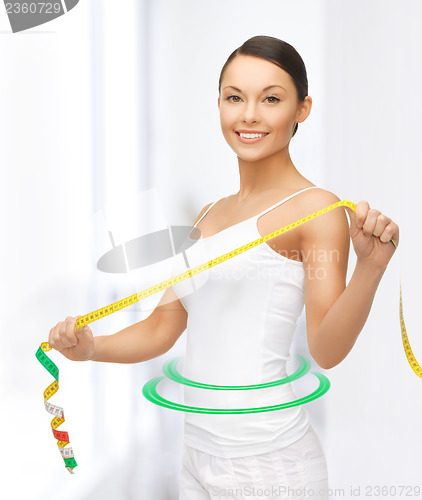 Image of sporty woman with measuring tape