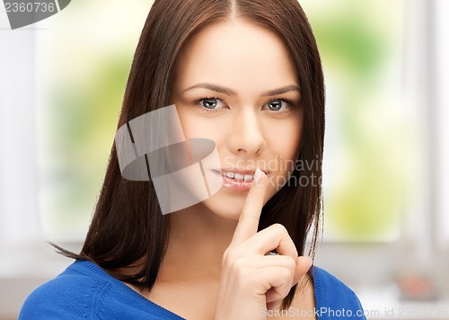 Image of woman with finger on her lips