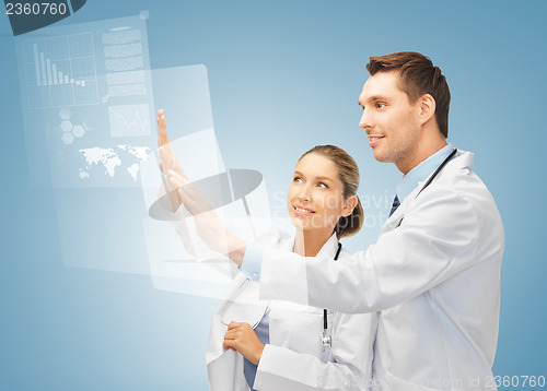 Image of two doctors working with virtual screen