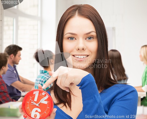 Image of girl holding big clock at school