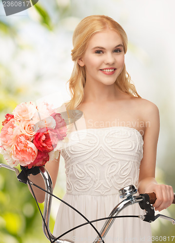 Image of country girl with bicycle and flowers