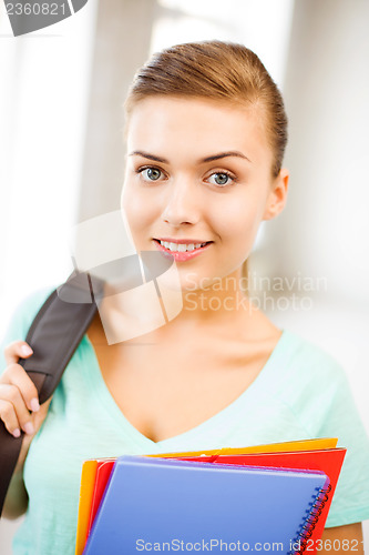 Image of student girl with school bag and color folders