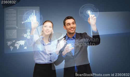 Image of two business people working with virtual screen