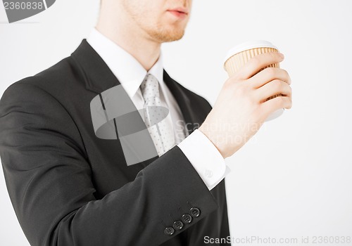 Image of man hand holding take away coffee