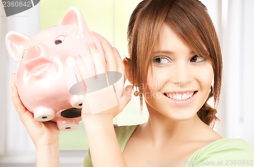 Image of lovely girl with big piggy bank