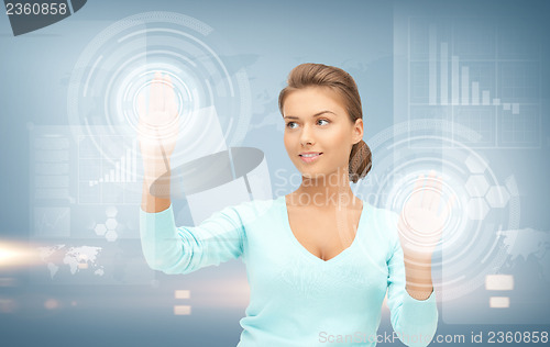Image of businesswoman working with virtual screens