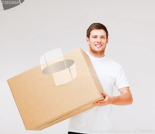 Image of smiling man carrying carton box