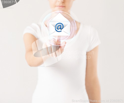 Image of woman pressing virtual button with e-mail icon