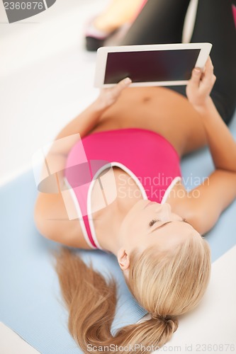 Image of woman lying on the floor with tablet pc