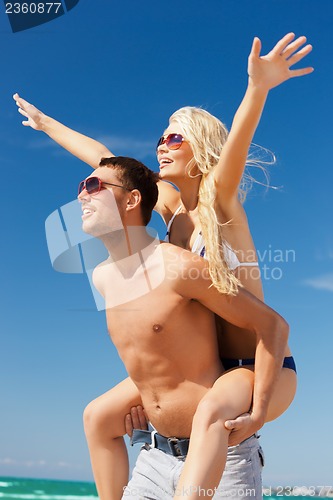 Image of couple having fun on the beach