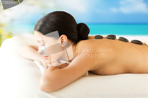 Image of woman in spa with hot stones