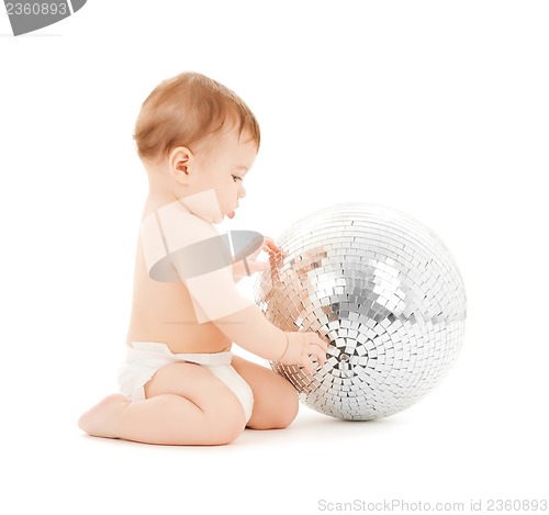 Image of child playing with disco ball