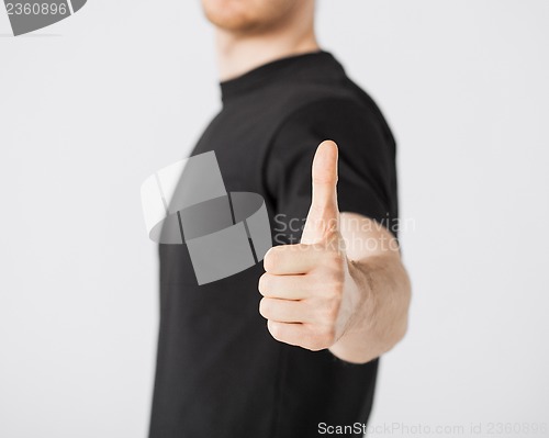 Image of man showing thumbs up