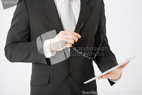 Image of man with tablet pc and eyeglasses