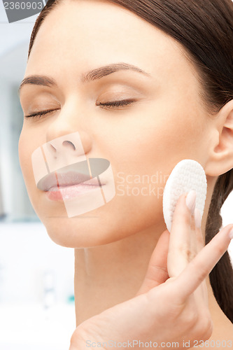 Image of beautiful woman with cotton pad