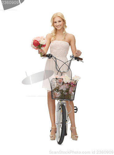 Image of country girl with bicycle and flowers