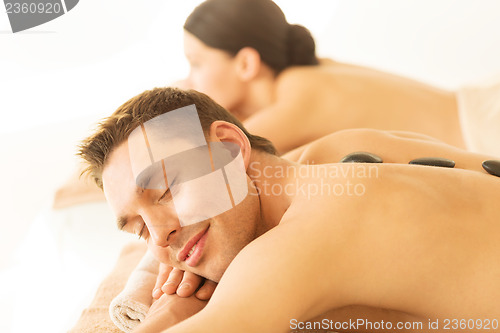 Image of couple in spa with hot stones