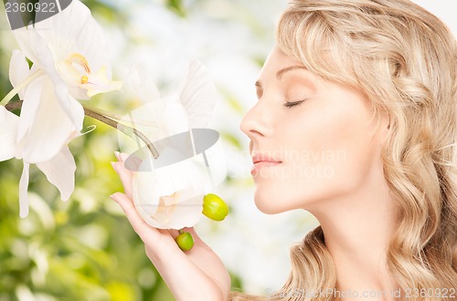 Image of beautiful woman with orchid flower