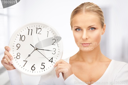 Image of woman holding big clock