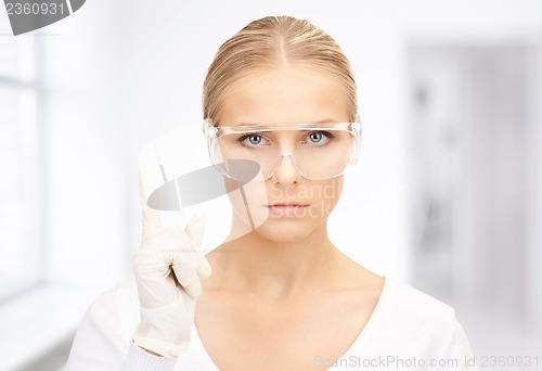 Image of woman in protective glasses and gloves