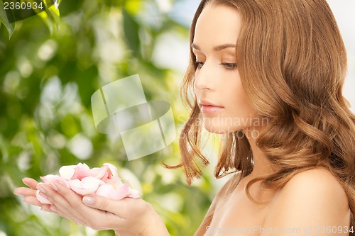 Image of beautiful woman with rose petals