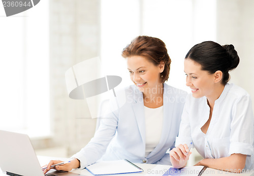 Image of businesswomen working with laptop in office