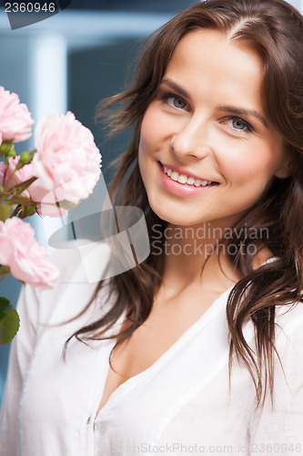 Image of woman with bouquet of flowers at home