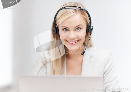 Image of friendly female helpline operator with laptop