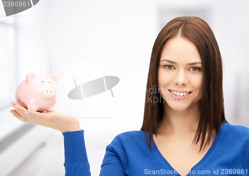 Image of lovely woman with piggy bank