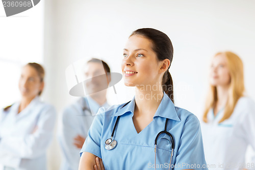 Image of female doctor in front of medical group