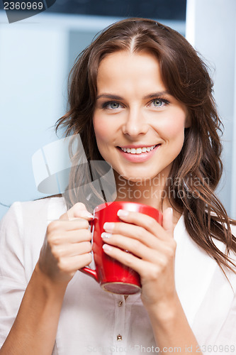 Image of smiling woman with red cup