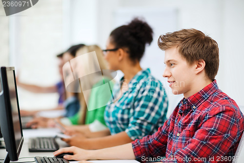 Image of student with computer studying at school