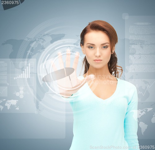 Image of businesswoman touching virtual screen