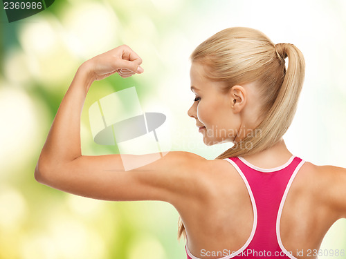 Image of sporty woman showing her biceps