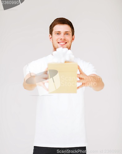 Image of man in white t-shirt with gift box