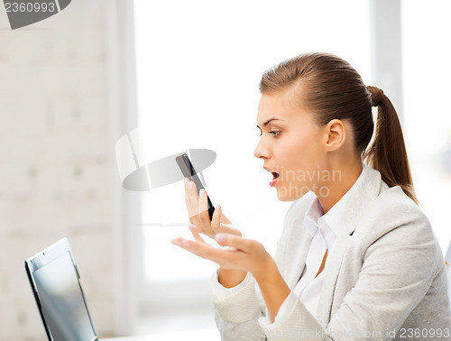 Image of woman shouting into smartphone