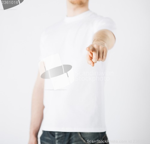 Image of man pointing his finger at you