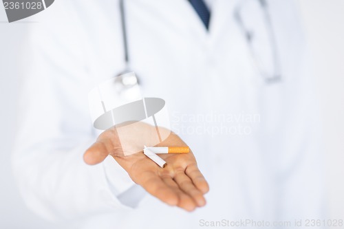 Image of man breaking the cigarette with hands