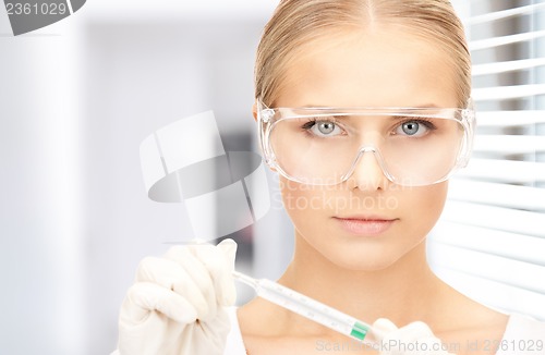 Image of attractive female doctor with thermometer