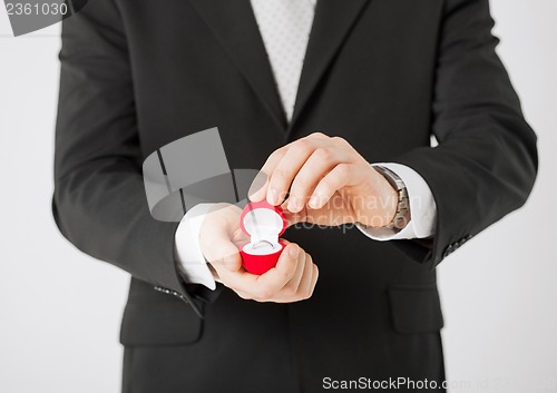 Image of man with gift box and wedding ring