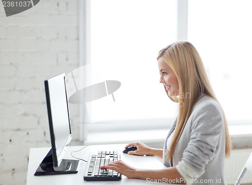 Image of businesswoman with computer in office