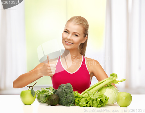 Image of woman shows thumbs up with organic food