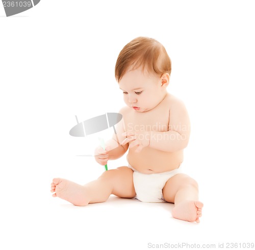 Image of curious baby brushing teeth