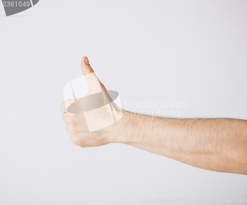 Image of man showing thumbs up