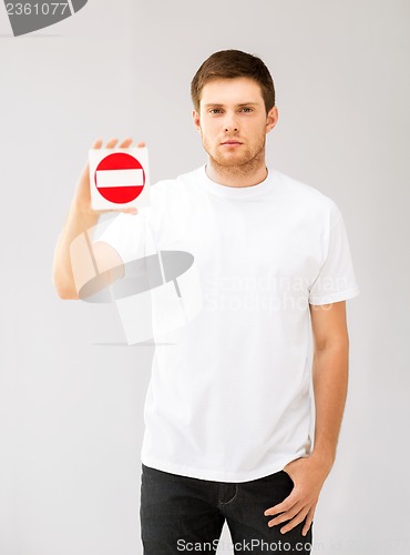 Image of young man showing no entry sign