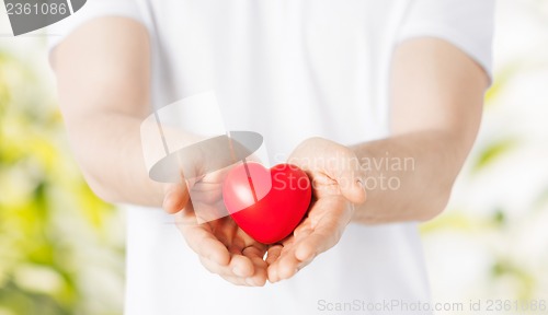 Image of man hands with heart