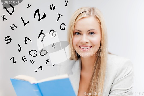 Image of young woman reading book